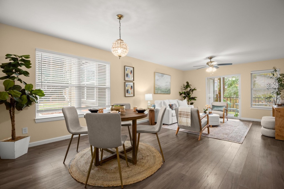 Dining area with dark wood-style floors, baseboar