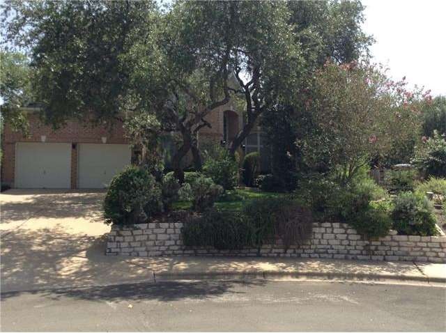 Brick exterior on quiet street with lots of landsc