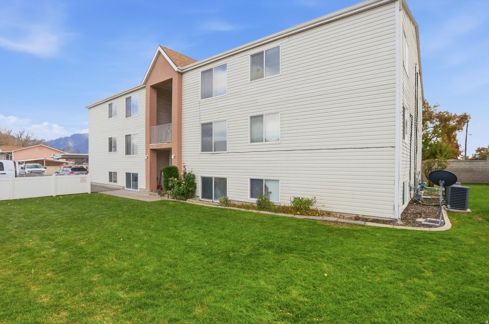 Front of condo building featuring a mountain view