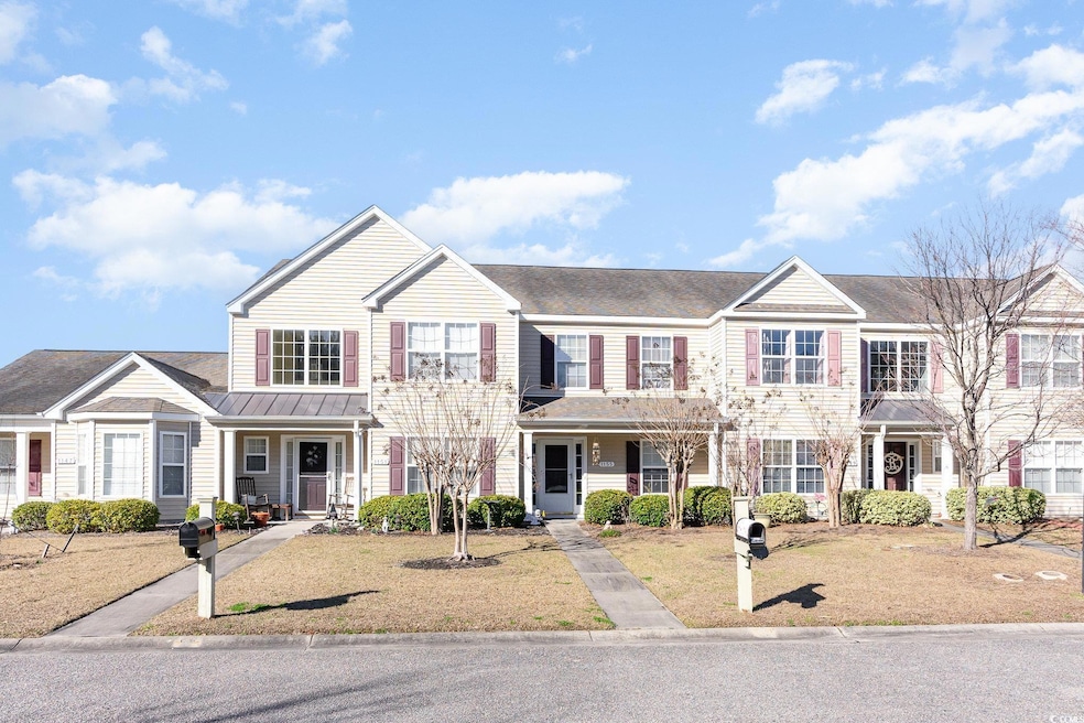 Townhome / multi-family property with a front yard