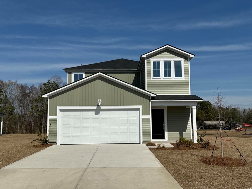 View of front of home with a shingled roof, drivew