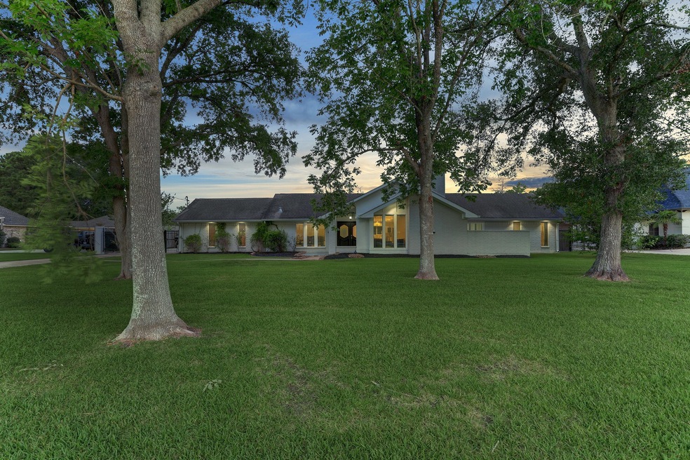 Beautiful front view of the house and far from the highway.  Lovely trees and expansive driveway. School bus picks up your children at the end of the driveway.  How convenient is that!