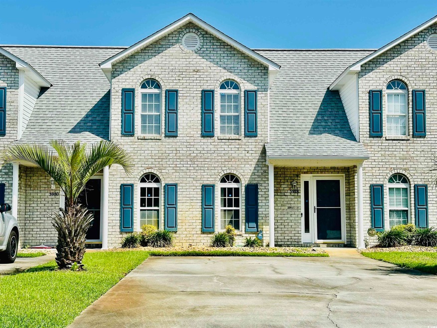 View of front of property with brick siding and a shingled roof