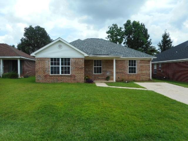 Ranch-style home with a front lawn