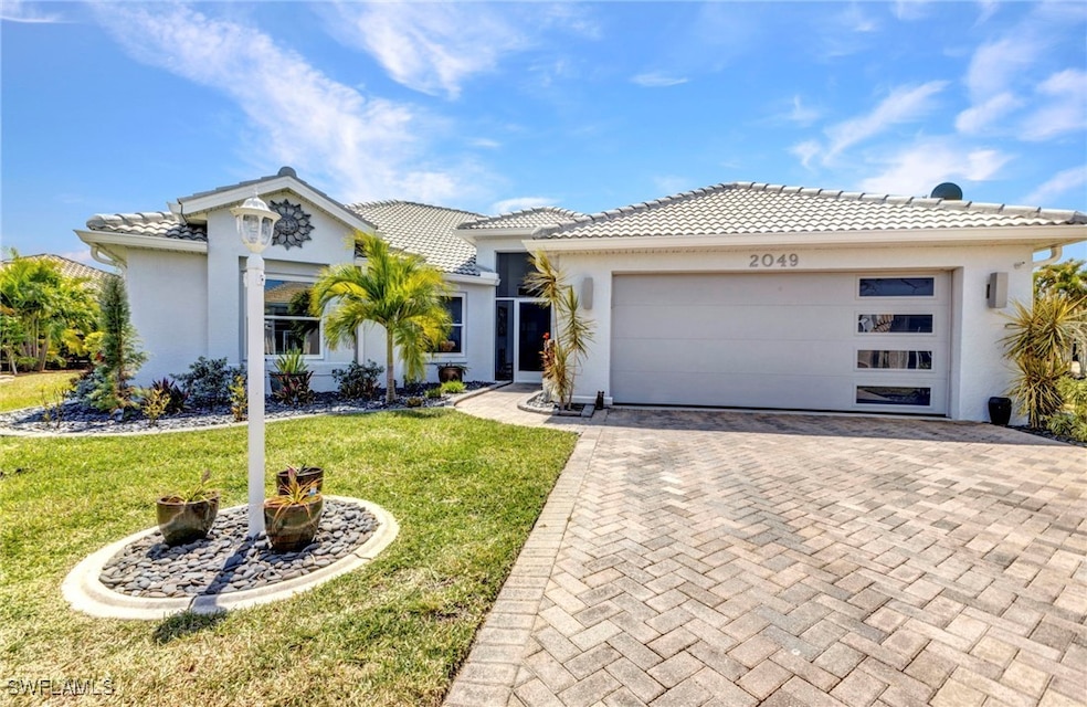 View of front of home with a tile roof, stucco sid