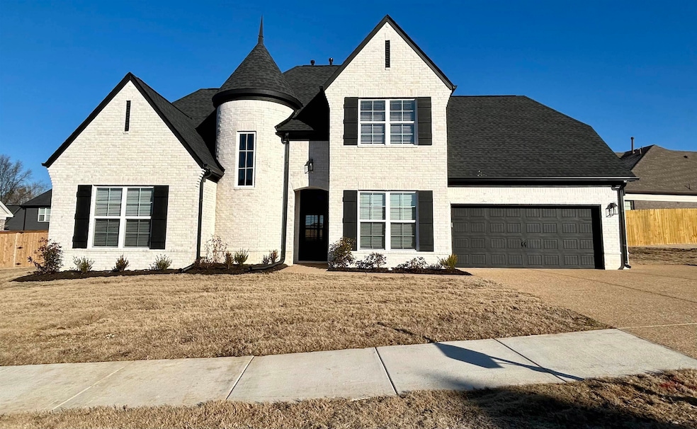 View of front of house with a front yard and a gar