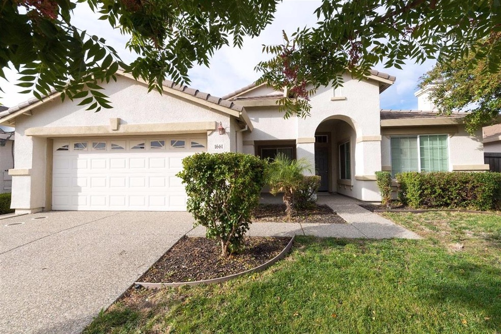 Beautiful home with tile roof and a large front la