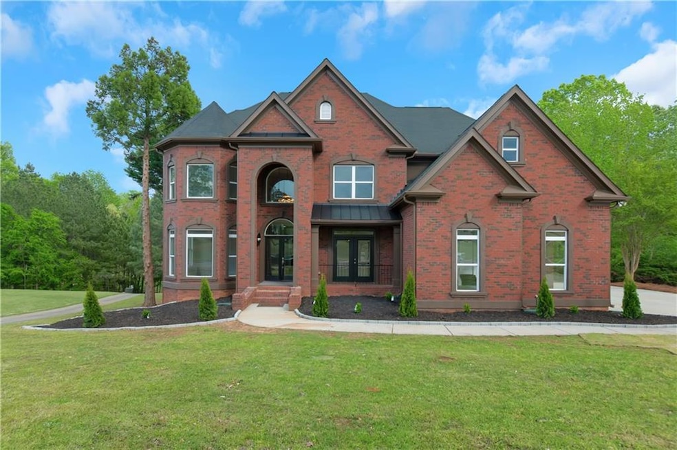 View of front of house with brick siding, french d