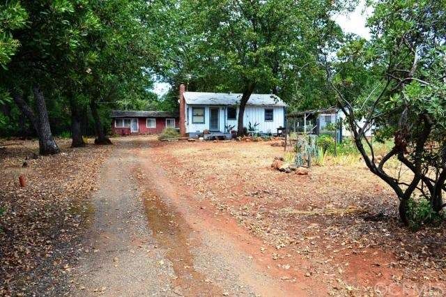 Two homes on Adjacent lots. The red home in the ba
