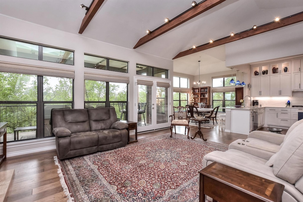 Living area featuring high vaulted ceiling, a cha