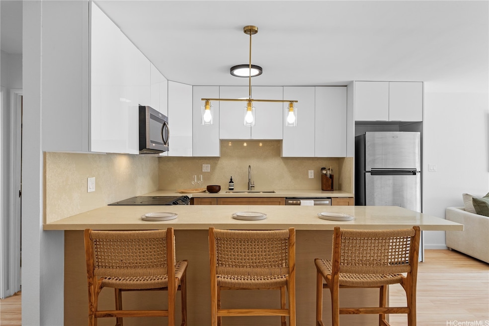 Fully remodeled kitchen with quartz countertops, backsplash, new modern fixtures and lighting (refrigerator not included in sale).
