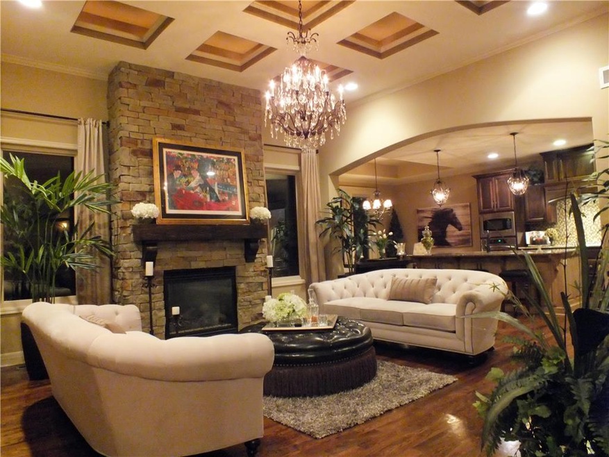 Elegant Great Room with stone fireplace, chandelie