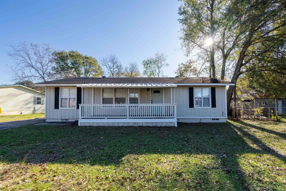 View of front of home with a front lawn and covere