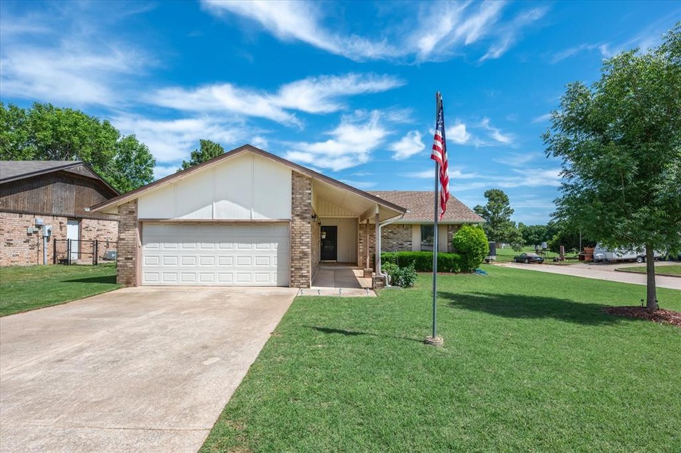 Ranch-style home featuring a garage and a front la