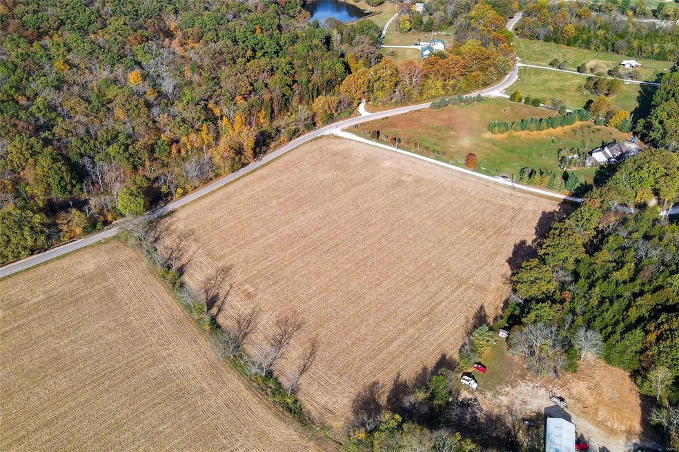 Property is tilled field in the middle of the pict