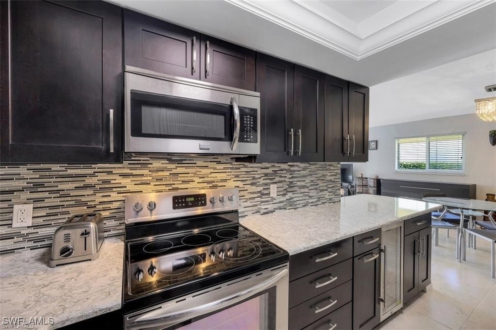 Kitchen with decorative backsplash, appliances wit