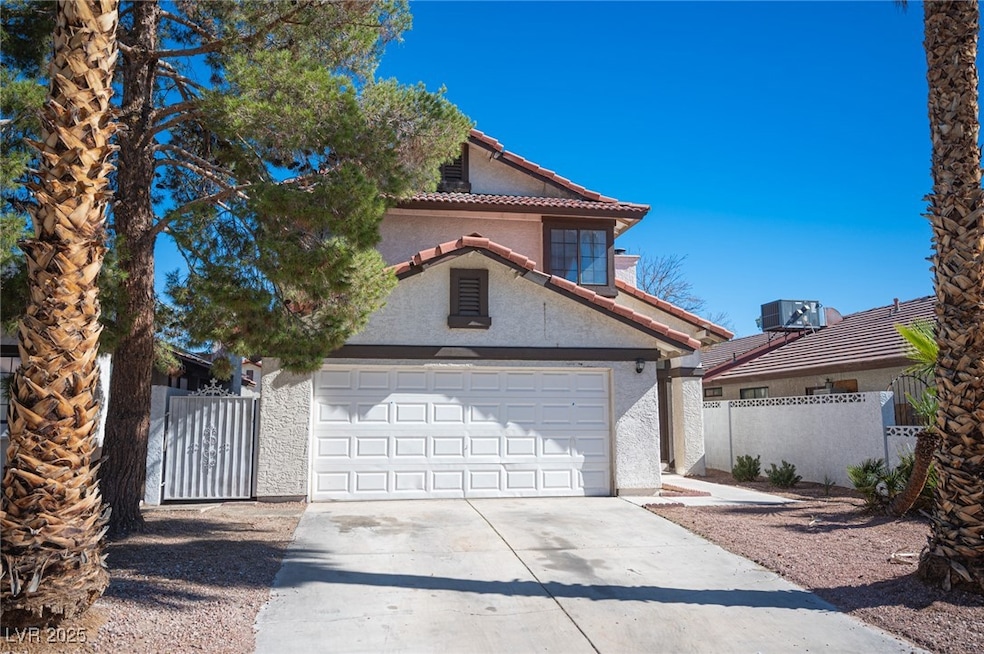 Mediterranean / spanish-style house featuring a tile roof, driveway, and stucco siding