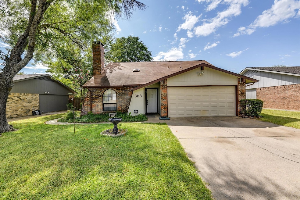 Cottage-style house featuring a front yard and a garage