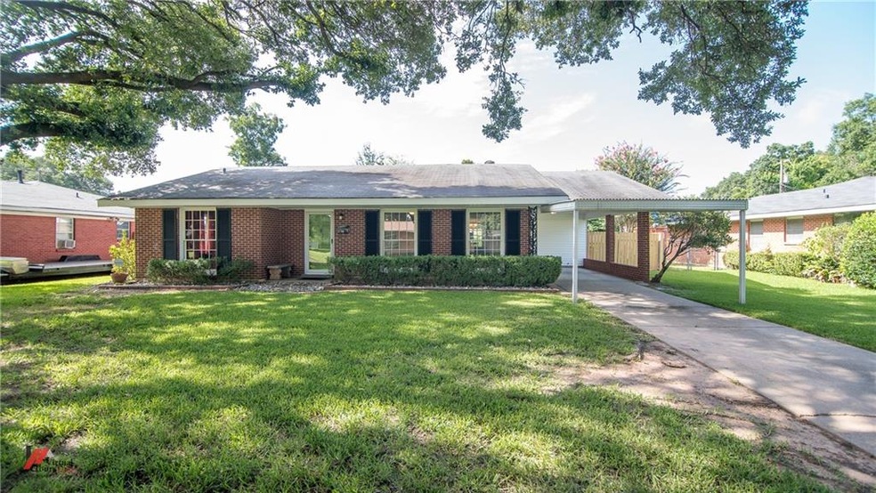 Beautiful brick home with enough covered parking f
