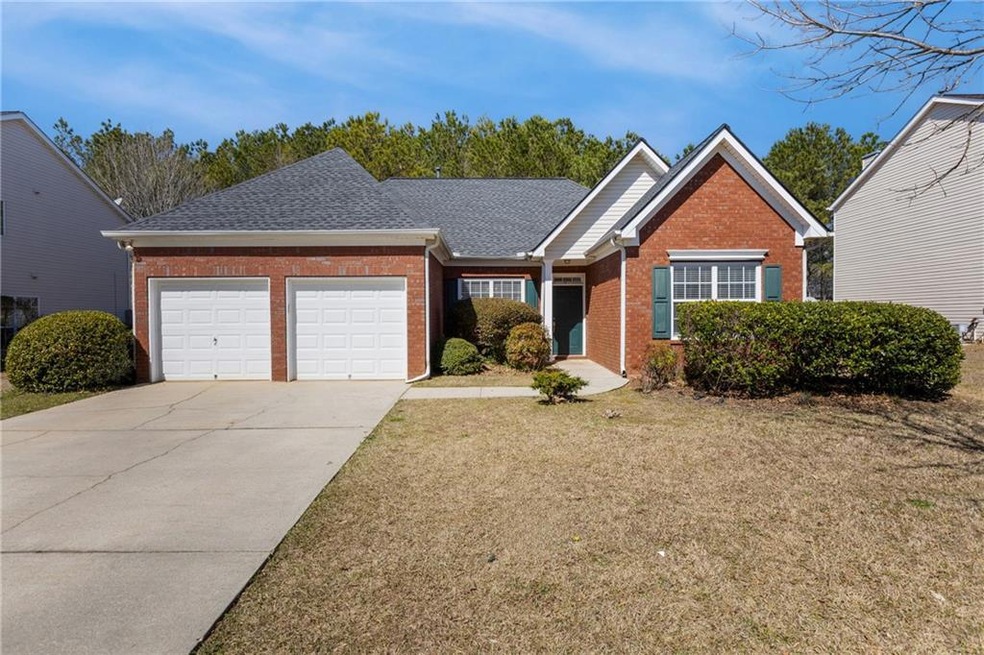 Single story home with a front yard, driveway, a s