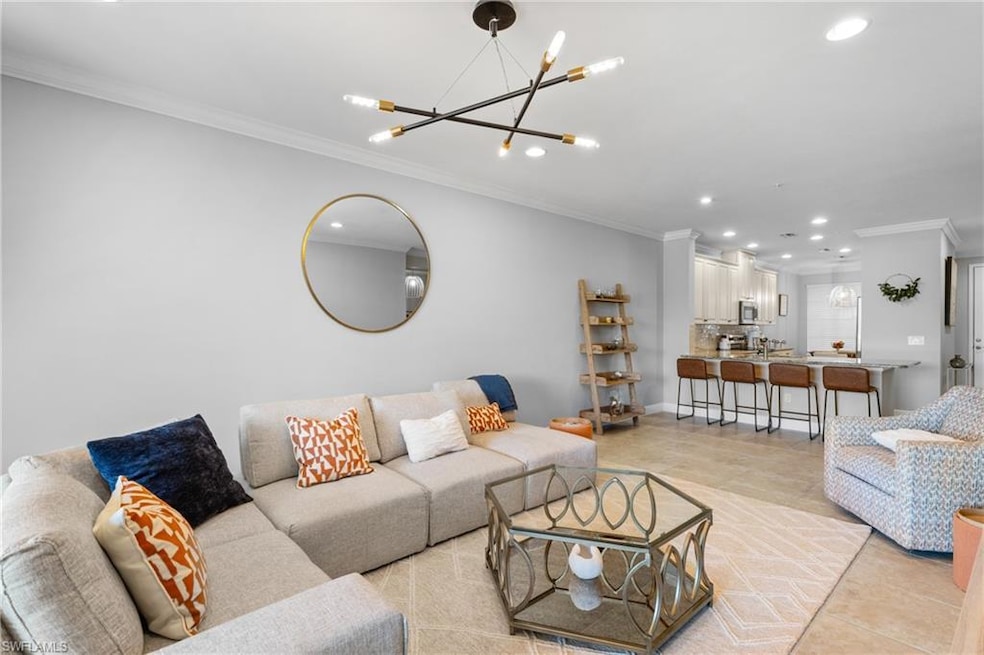 Living area with crown molding, recessed lighting,