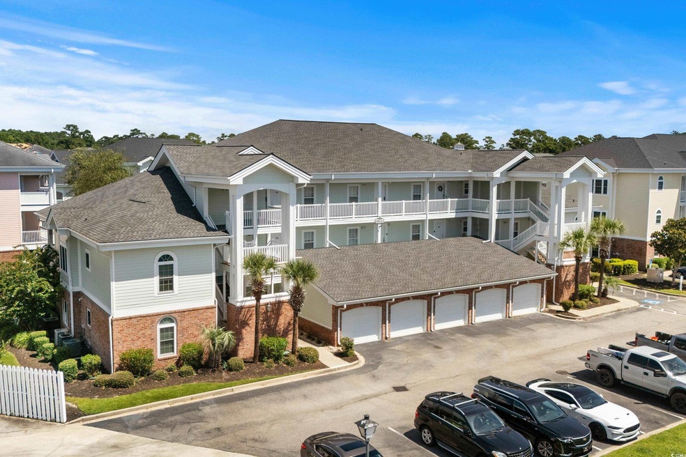 View of building exterior featuring a garage and c