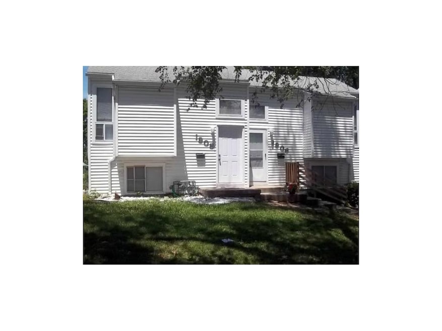 Front of Duplex has Vinyl Siding & landscaping