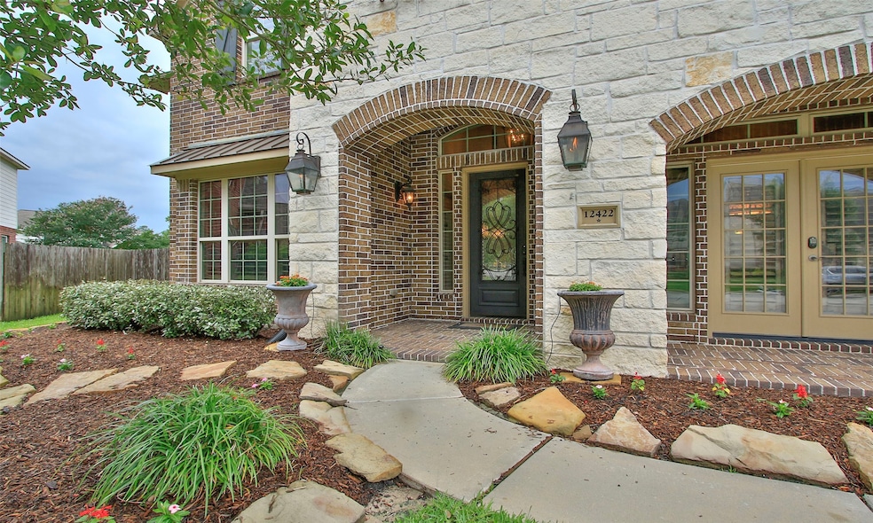 This home has beautiful stone accent at the entry with gas lanterns and covered front entry