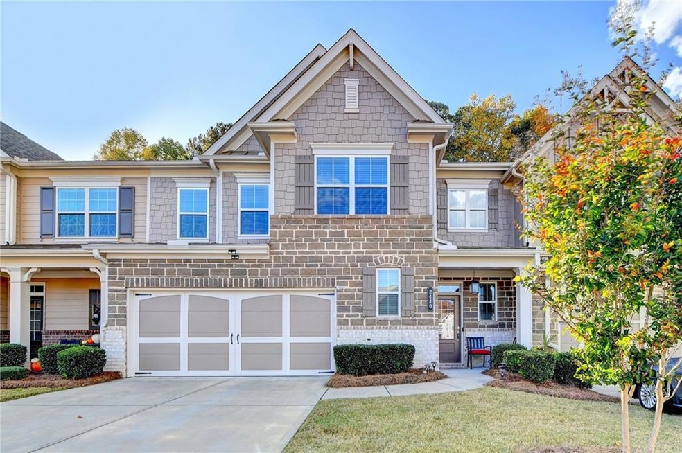 Craftsman-style home with a garage and covered por