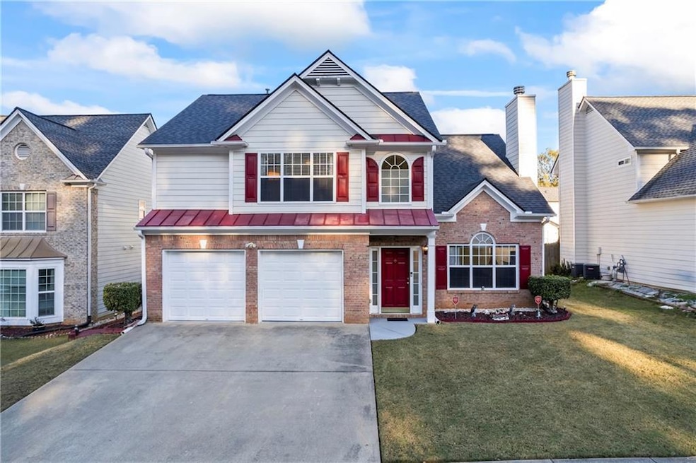 Front of property with a front lawn and a garage