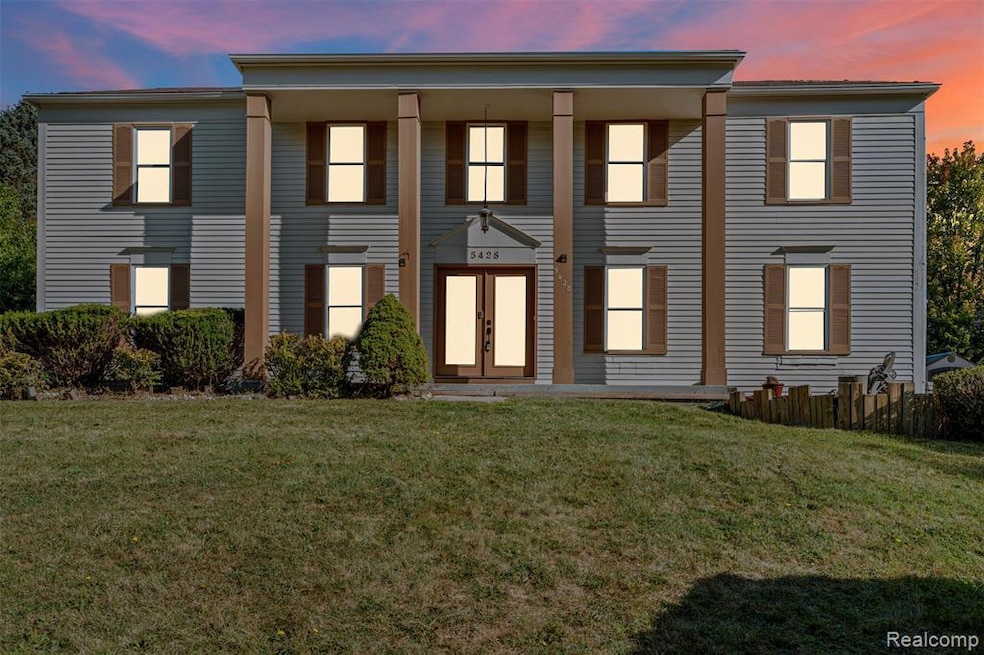 View of front facade with covered porch and a front lawn