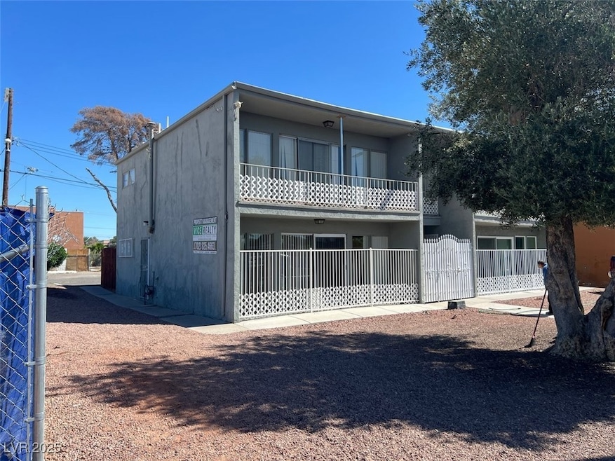 Back of property with stucco siding and fence