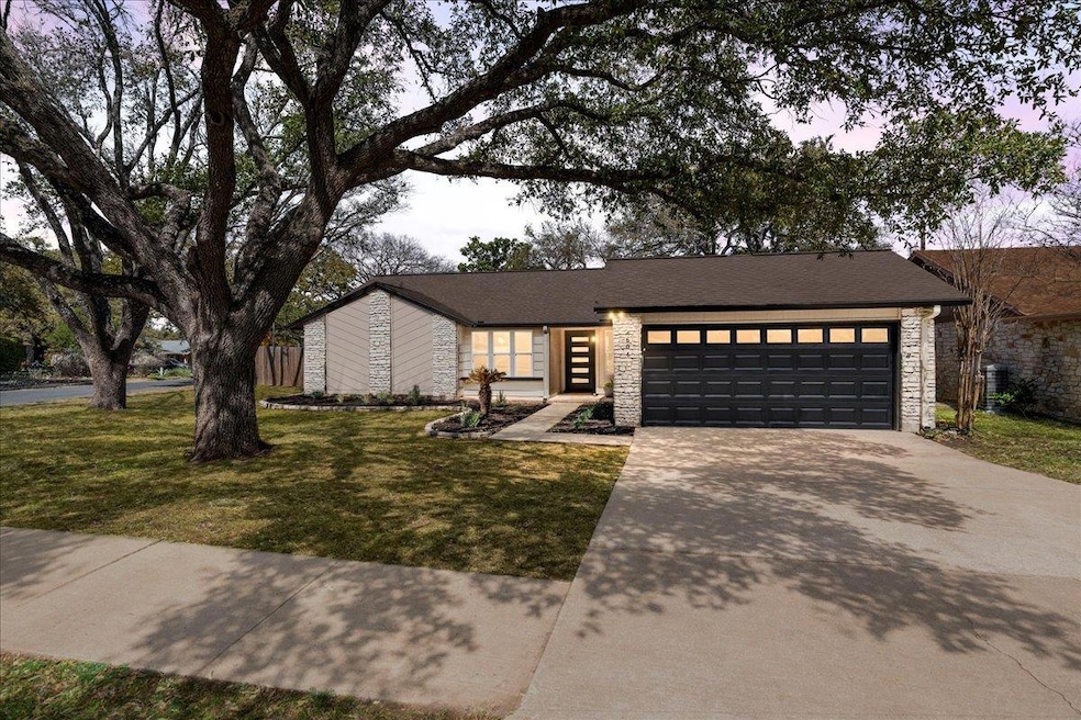 Mid-century home with concrete driveway, an attac