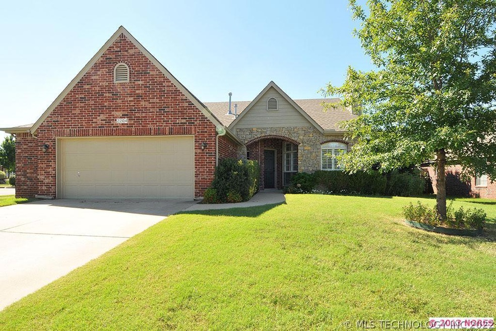 Exterior front with beautifully landscaped yard