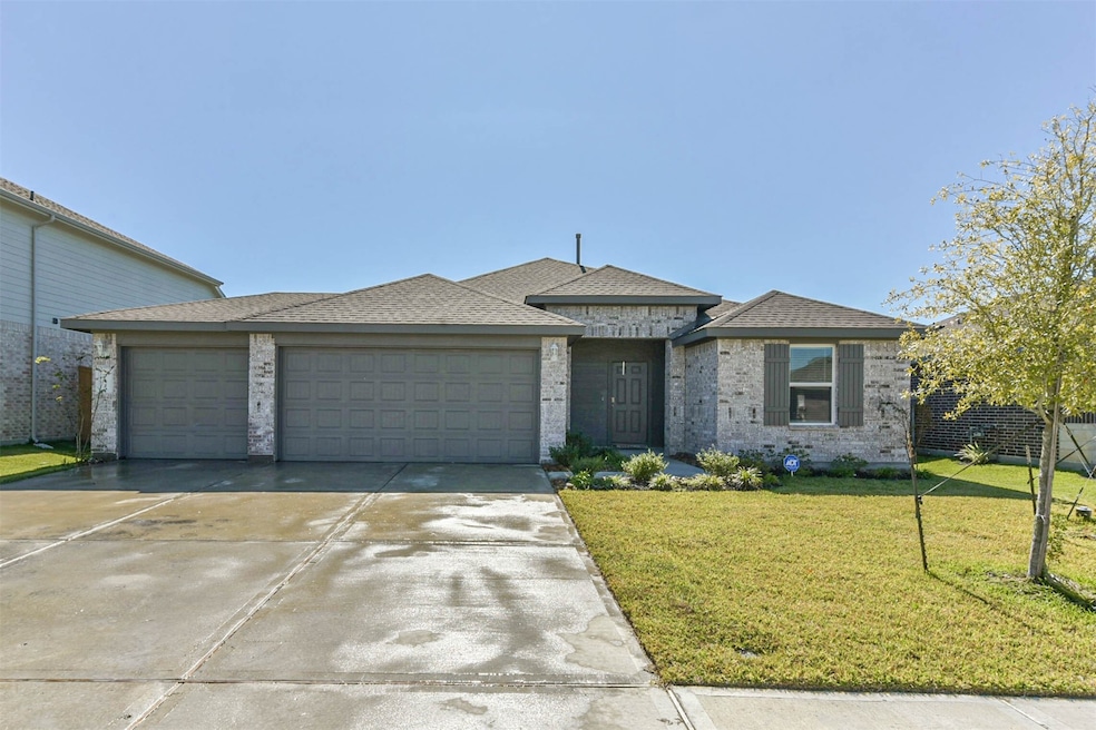 712 Brazos Trail offers 3 car garage and manicured lawn.