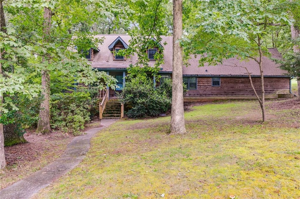 View of front facade with stairway and a front lawn