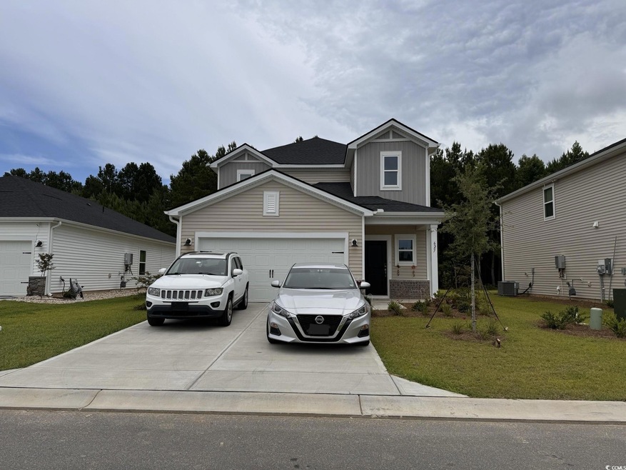 View of front facade featuring a garage and a fron