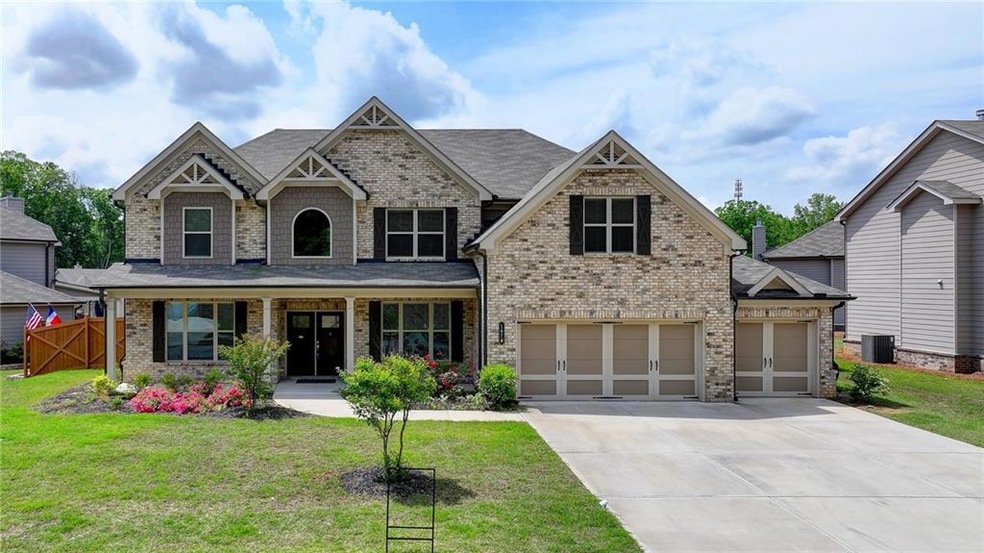 Craftsman inspired home featuring a garage and a f