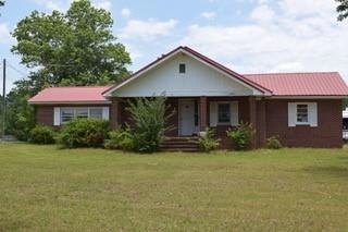 Single story home featuring a front lawn