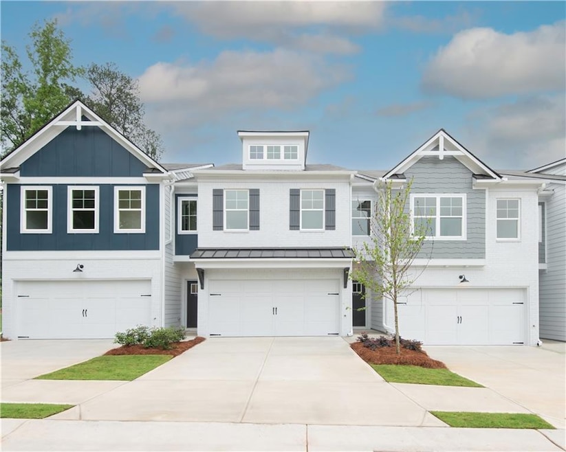 Townhome / multi-family property featuring an attached garage and driveway