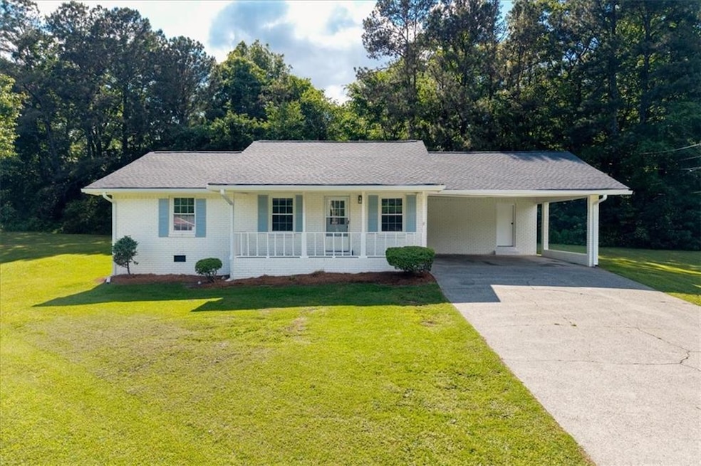 Ranch home featuring a porch, concrete driveway, a
