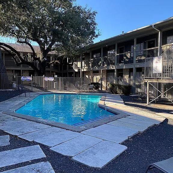 Community pool with a patio