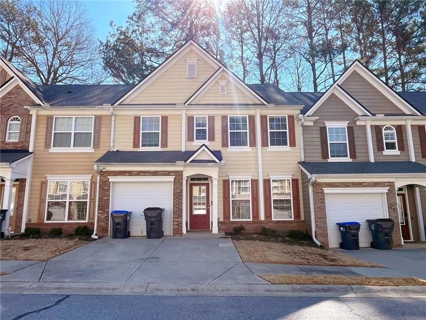 Multi unit property featuring driveway, brick sidi