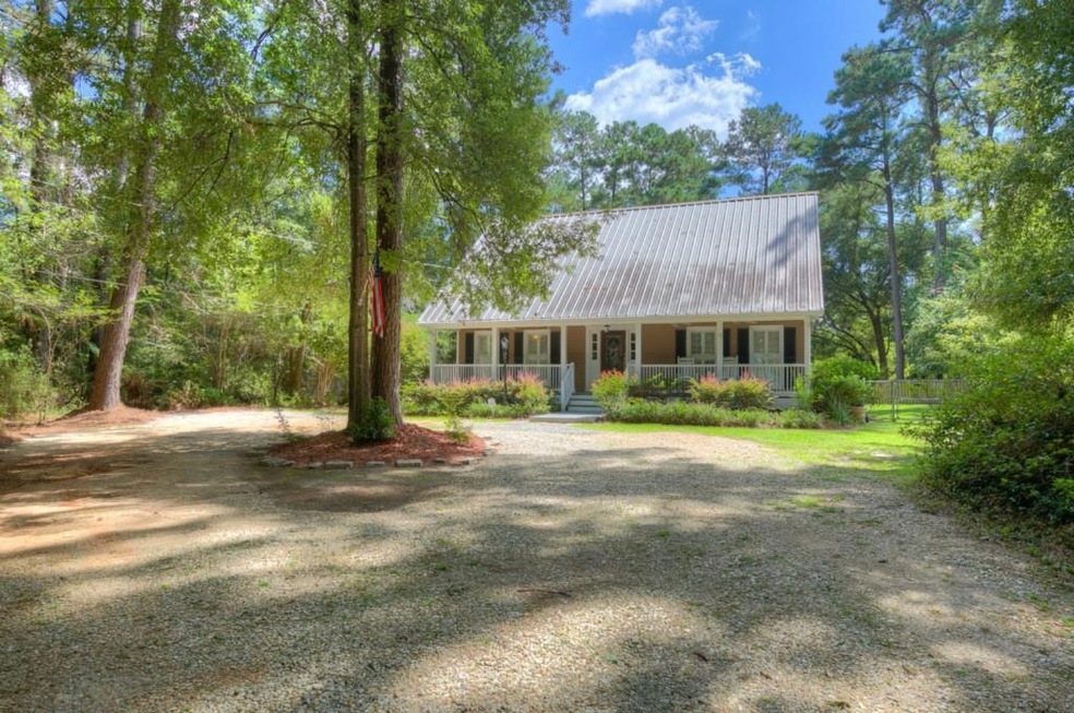 Beautiful Acadian with metal roof, covered porch,