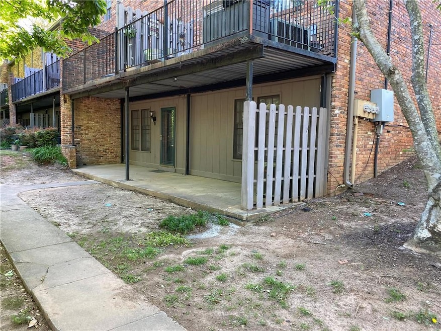 Back of property featuring brick siding and a pati