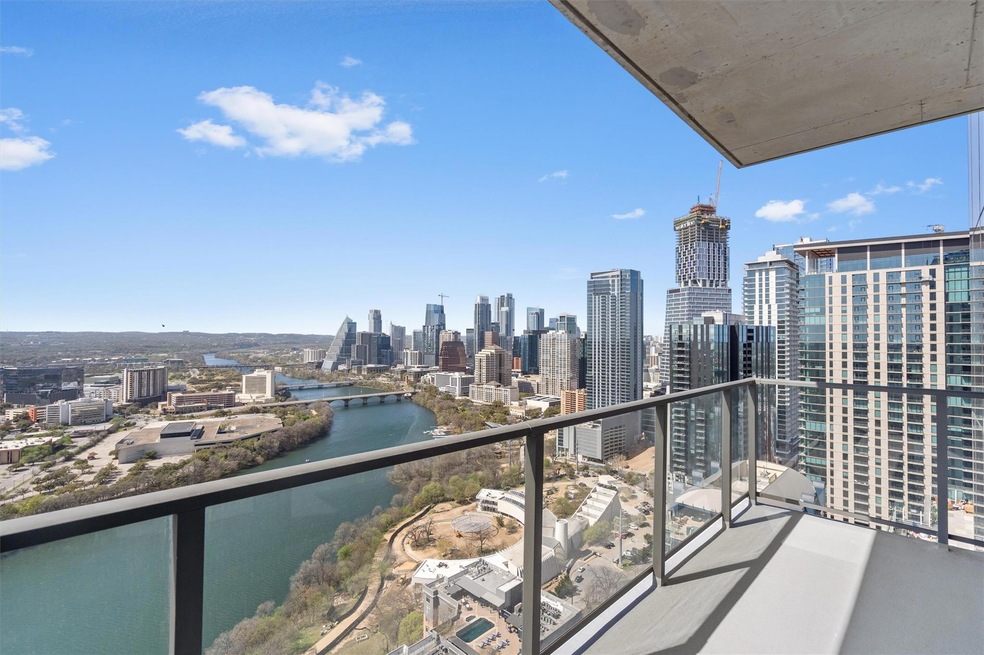 Balcony featuring a view of city and a water view