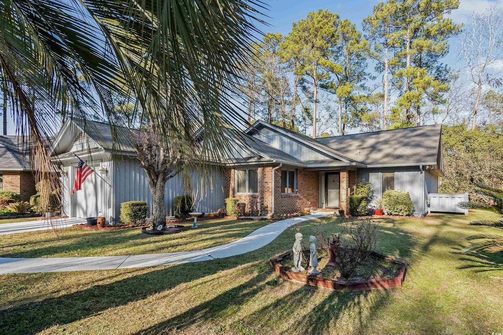 Ranch-style home featuring a front lawn