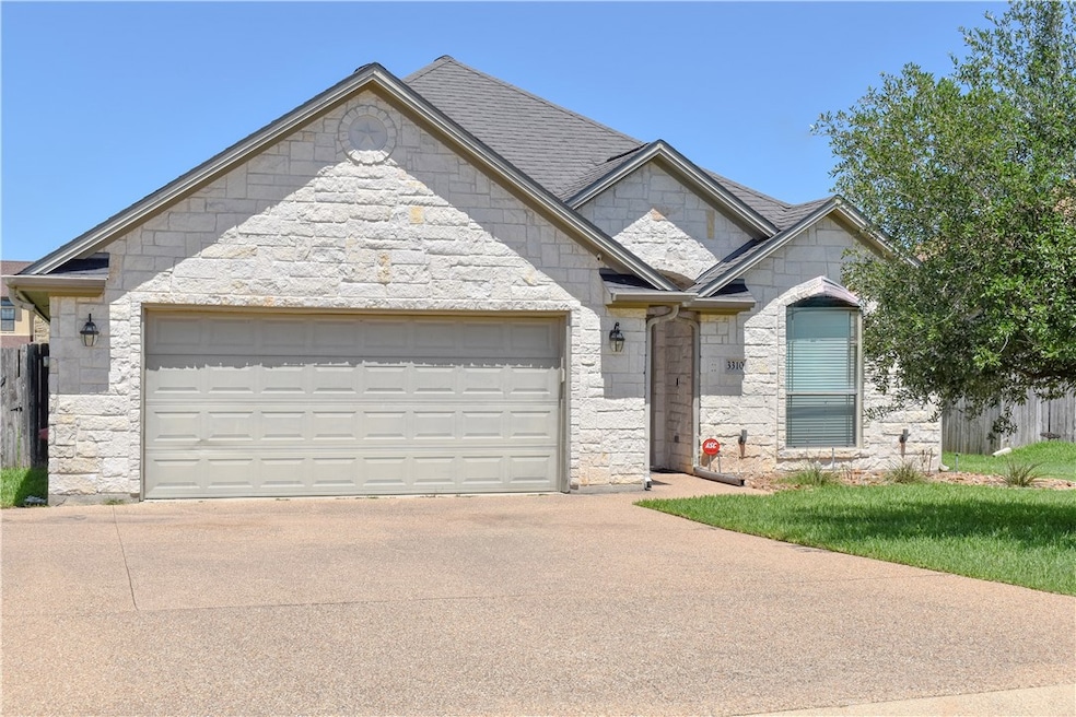 French provincial home with stone siding, driveway