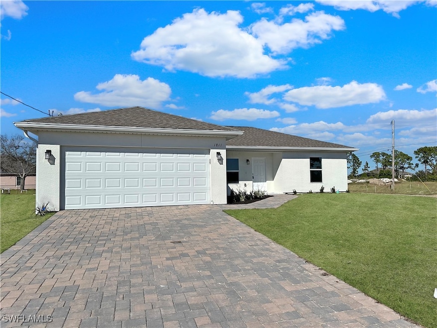 Ranch-style house with decorative driveway, a fron