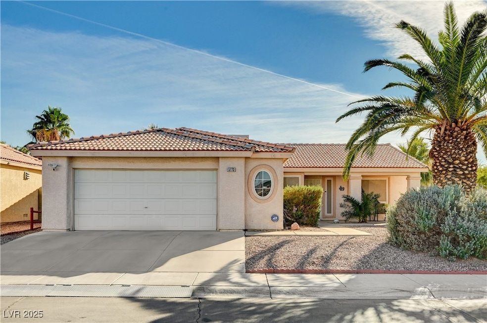Mediterranean / spanish home with stucco siding, concrete driveway, a tiled roof, and a garage